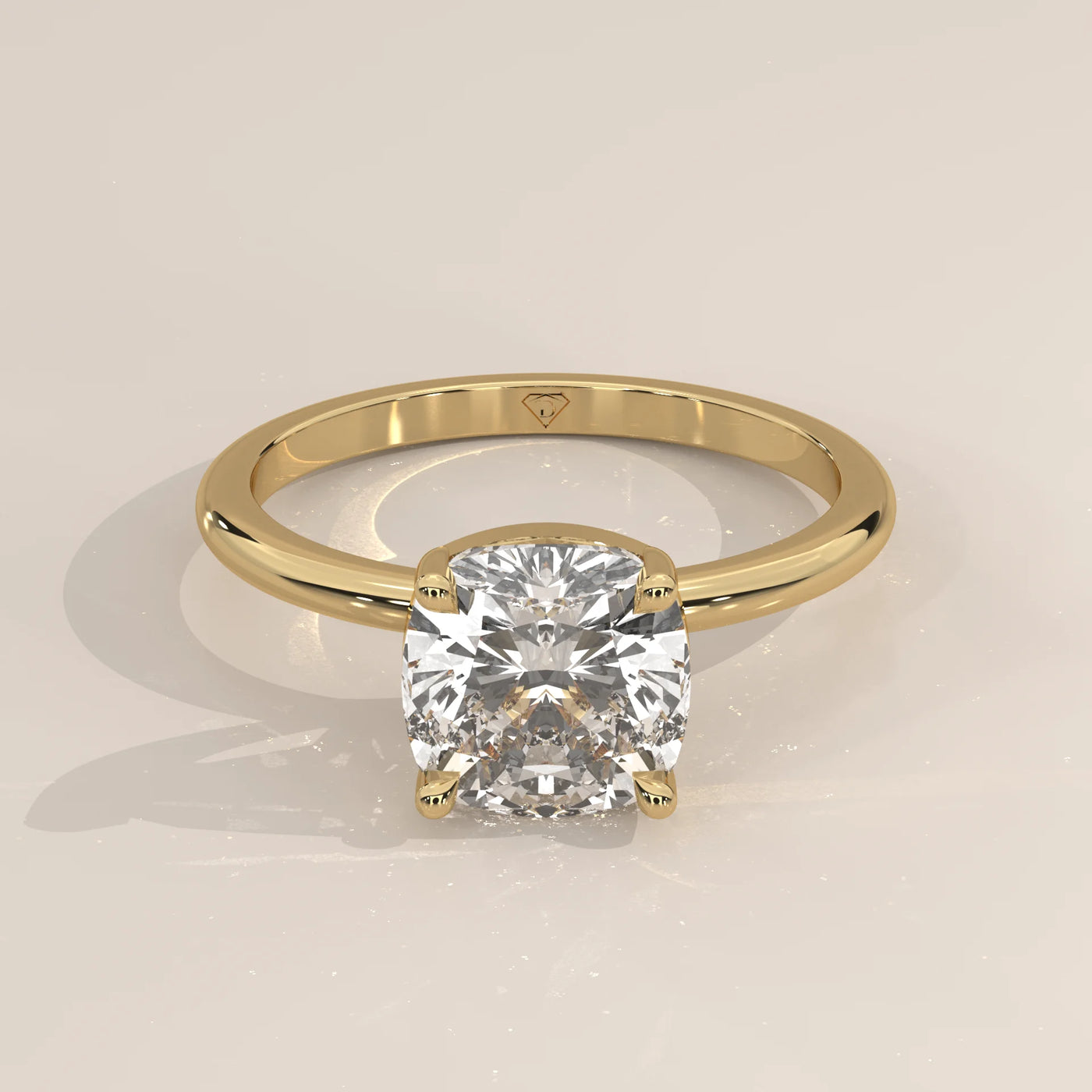 Yellow gold engagement ring with a cushion-cut diamond.