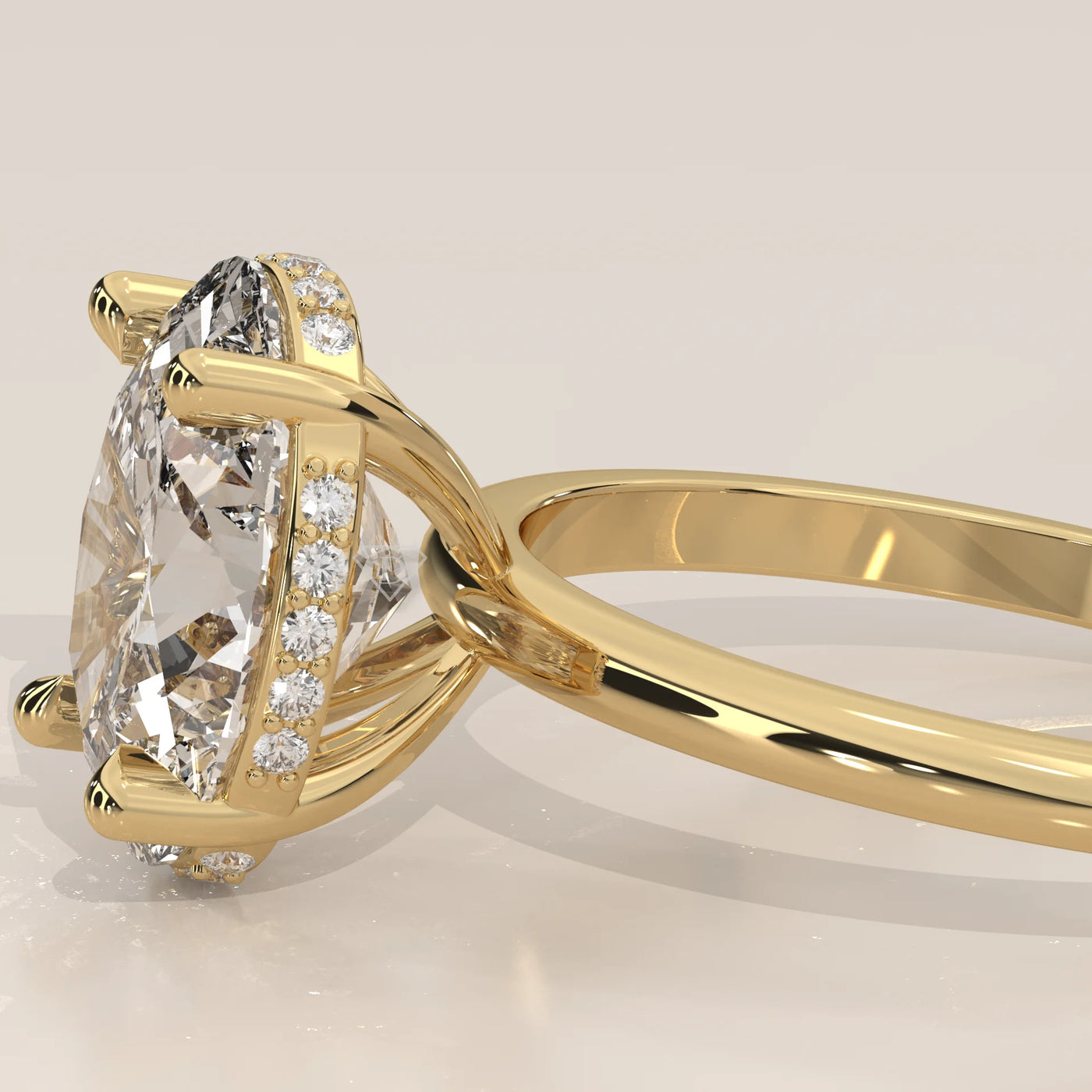 A yellow gold engagement ring with a large, clear diamond and pavé band.