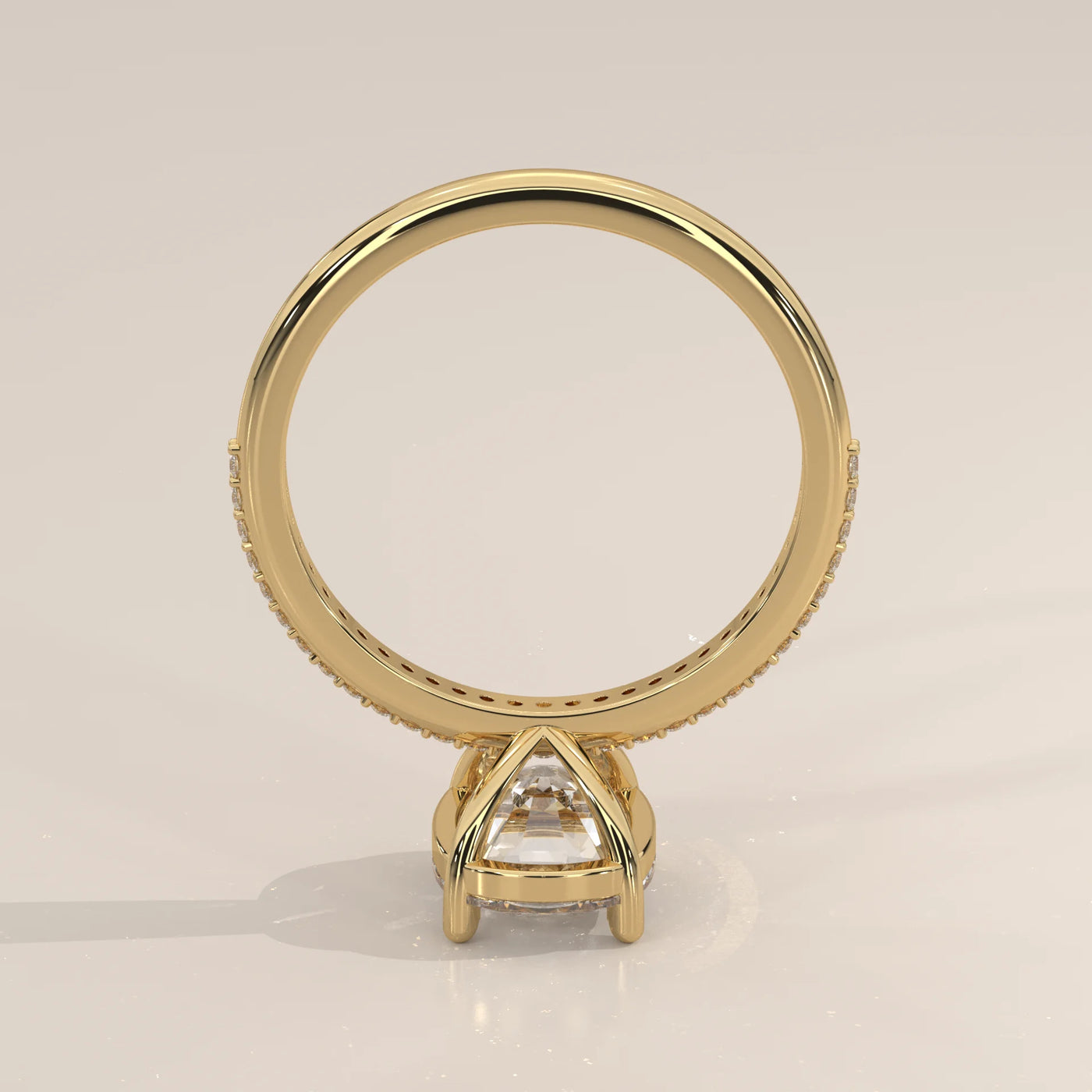 A yellow gold engagement ring with a large, clear diamond and pavé band.