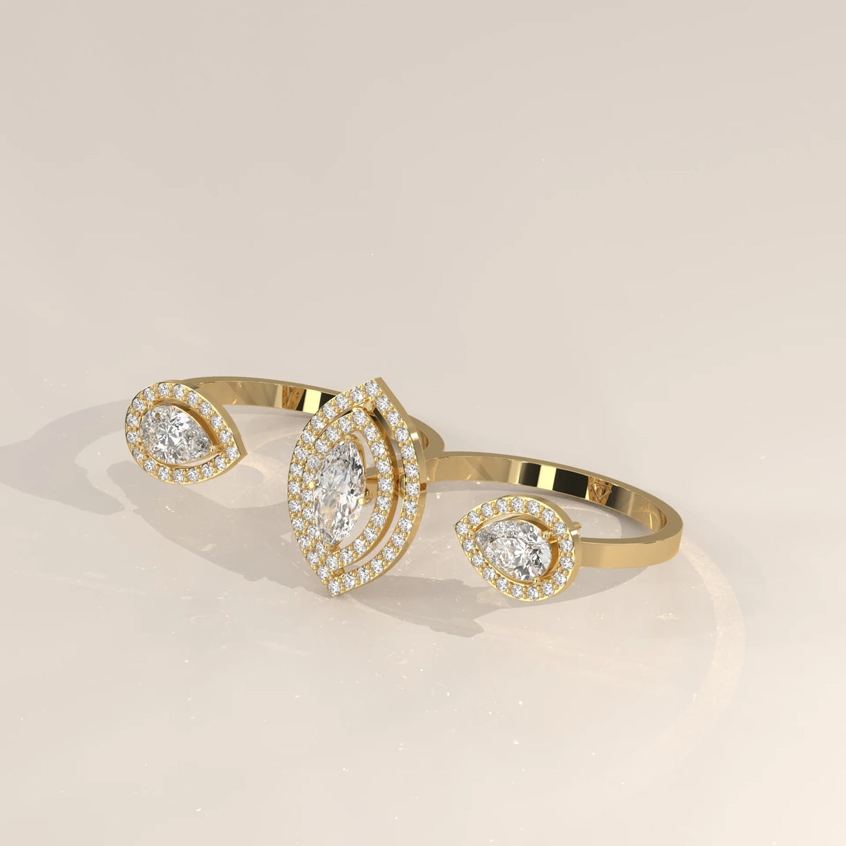 Marquise Lab Grown Diamond Double Halo Two Finger Ring with Pear Ends in yellow gold, shown on a plain background.