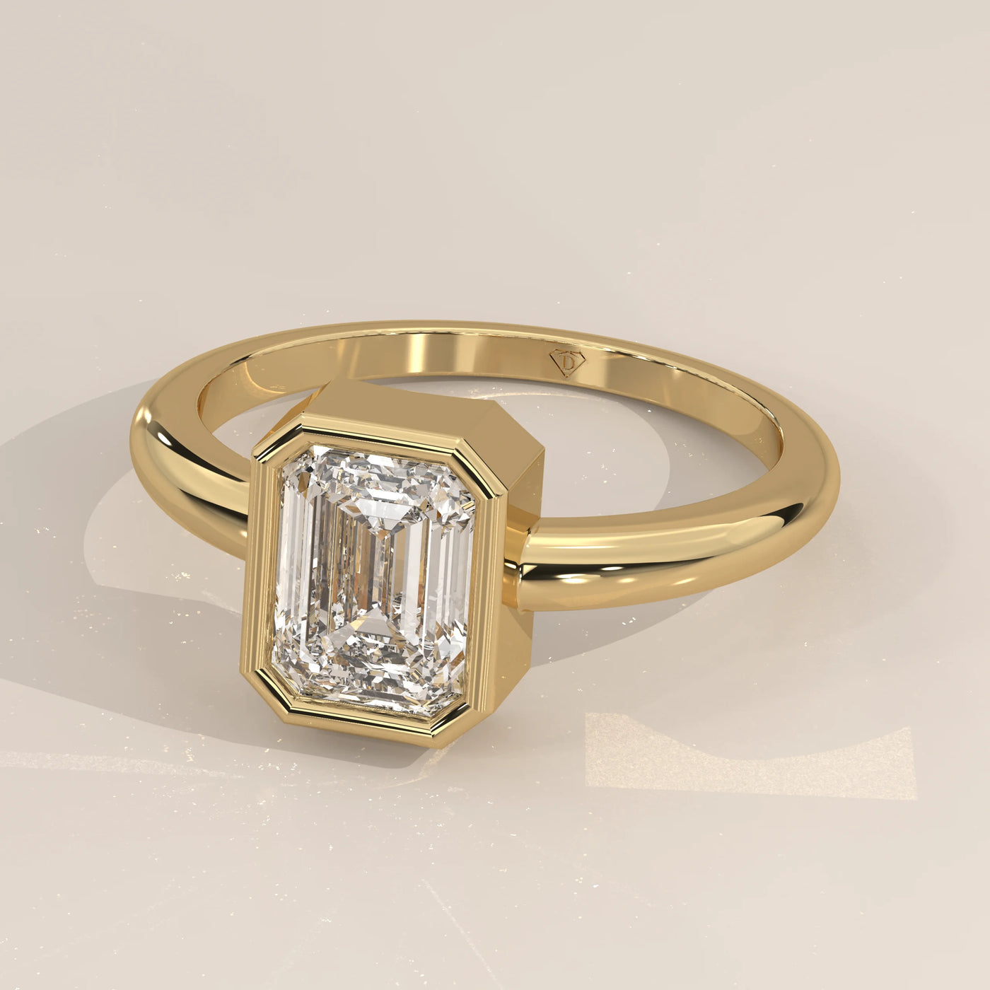 Elegant 14k yellow gold ring featuring an emerald-cut diamond in a secure bezel setting.