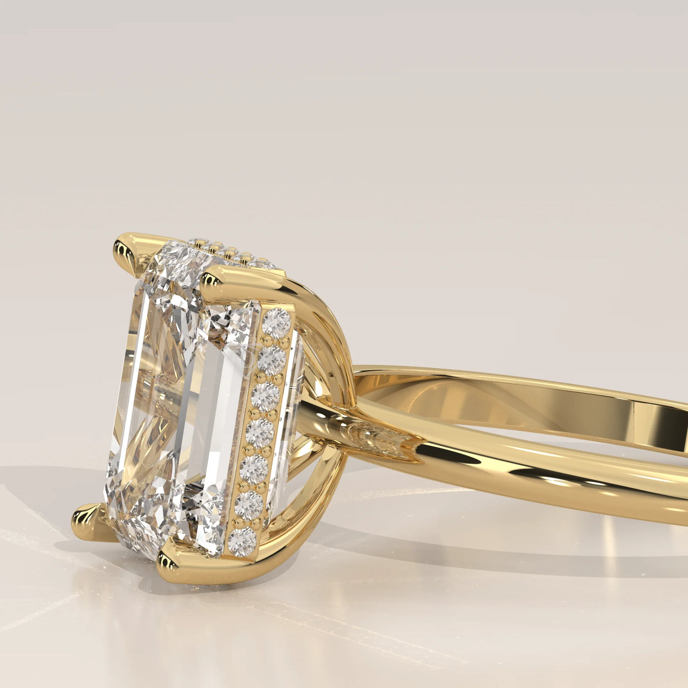 A gold ring with an emerald-cut diamond and smaller diamonds on the band.