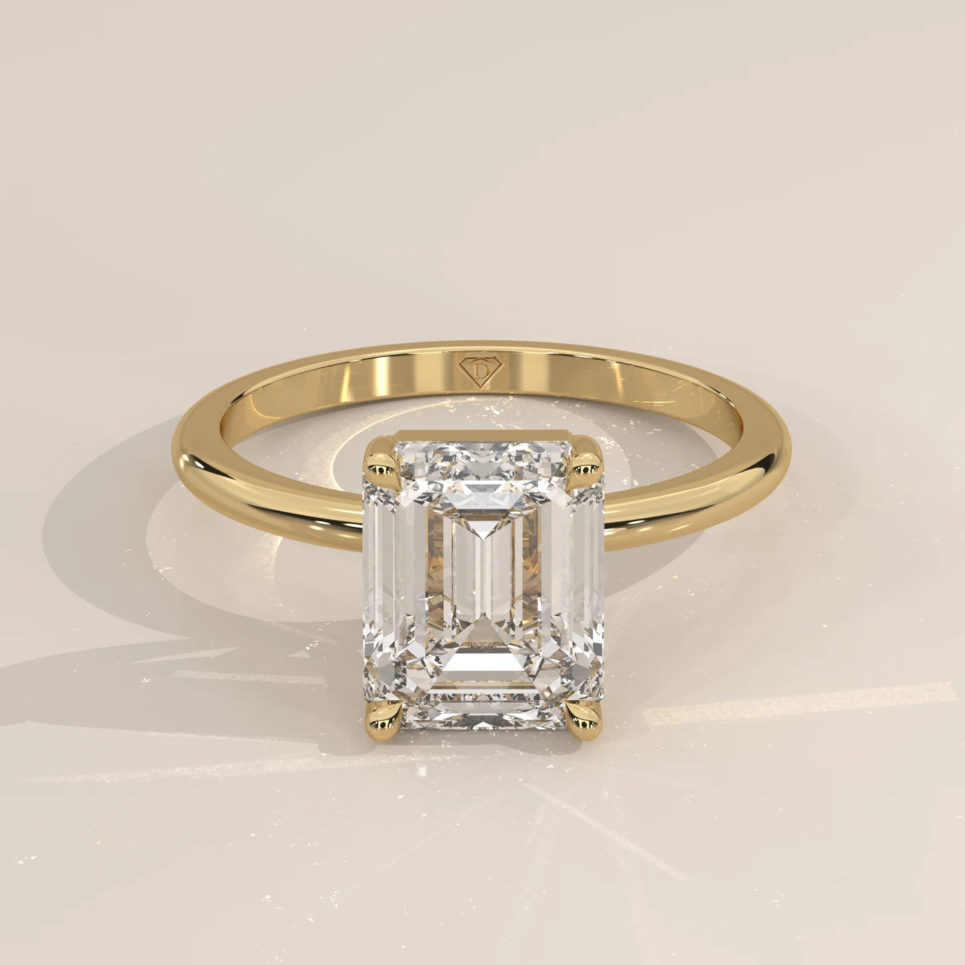 Emerald cut diamond ring in yellow gold with pave diamond band.
