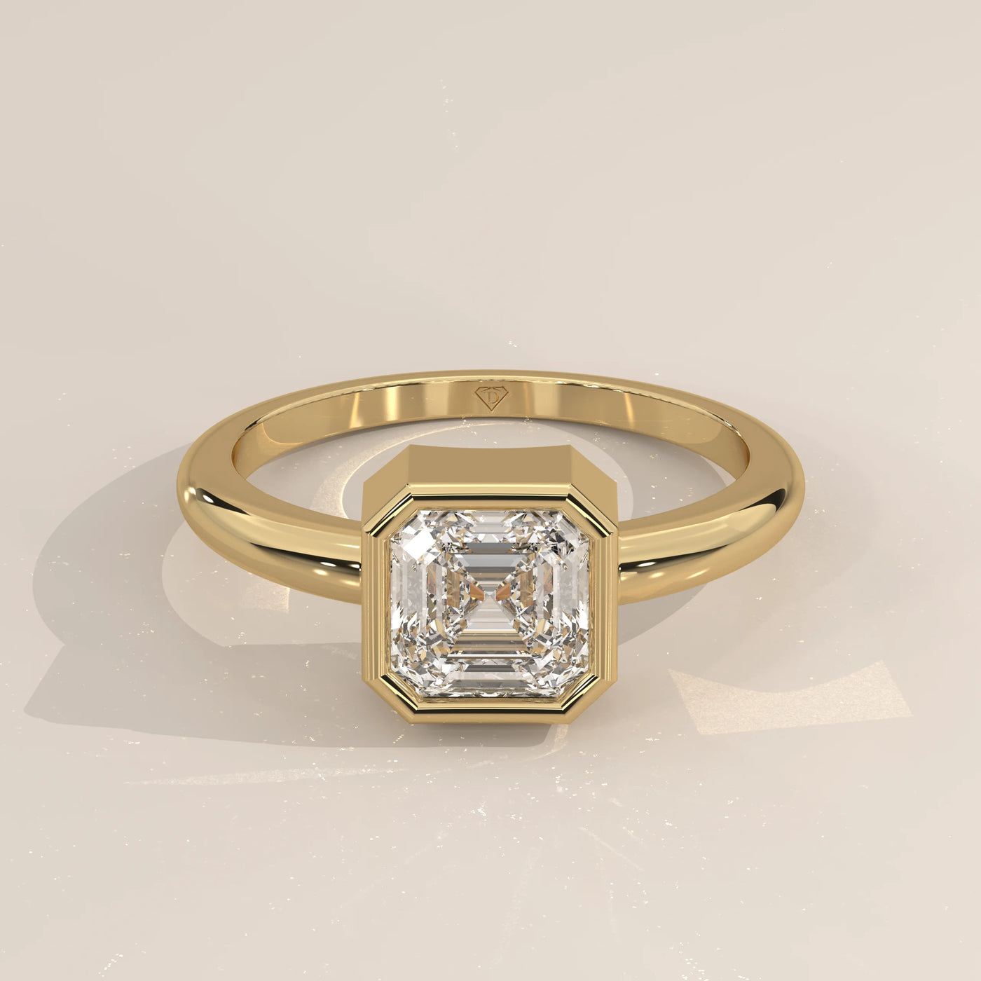 Emerald cut diamond ring in yellow gold with pave diamond band.