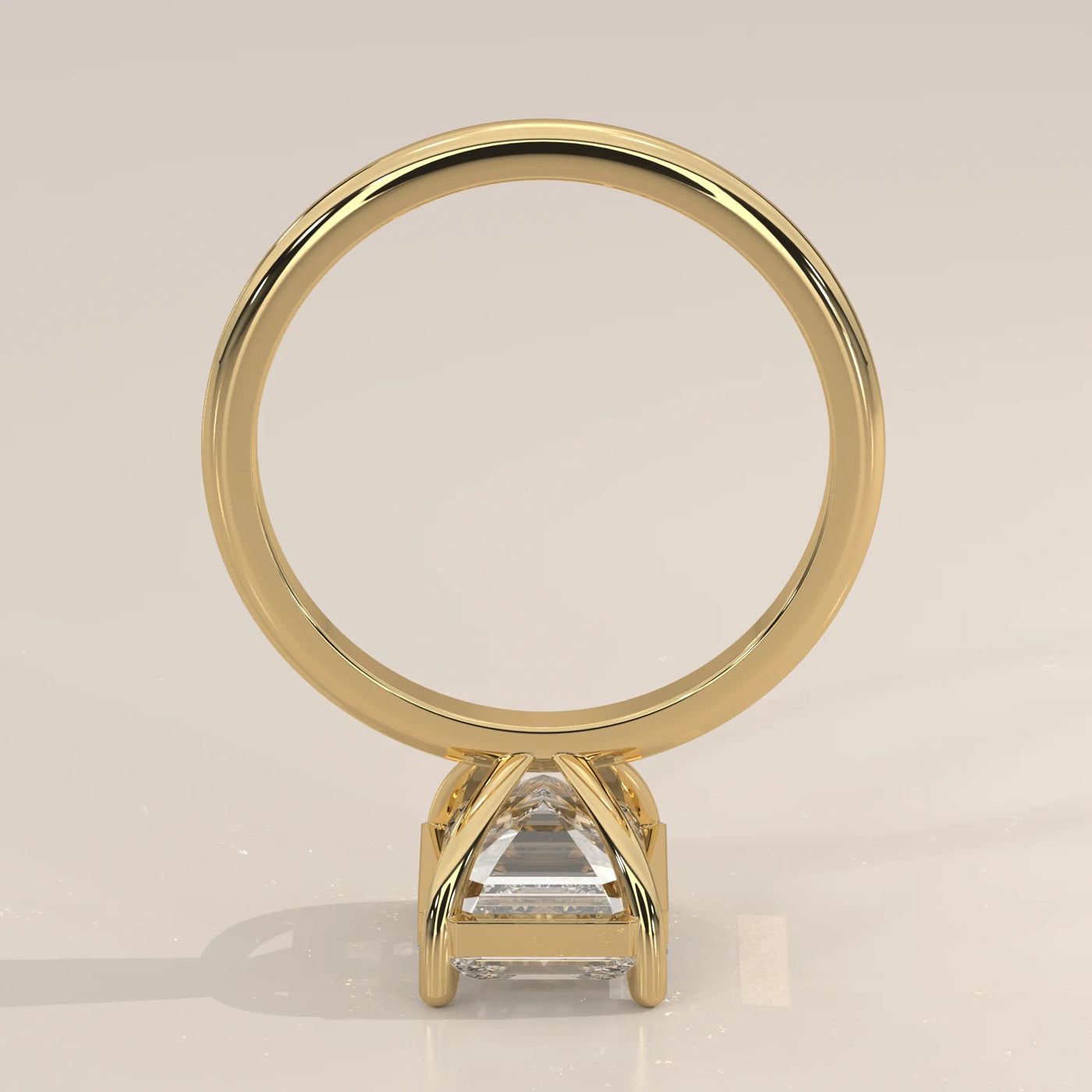 A 14k yellow gold ring with an emerald-cut diamond and pavé band.
