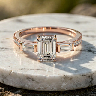 Flat-Lay: Emerald Cut Diamond Ring with Three Stone Setting in 14k Rose Gold - Lab Grown - Driona Jewels