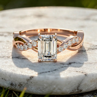 Flat Lay: Emerald Cut Diamond Ring with Twist Setting in 14k Rose Gold - Lab Grown - Driona Jewels