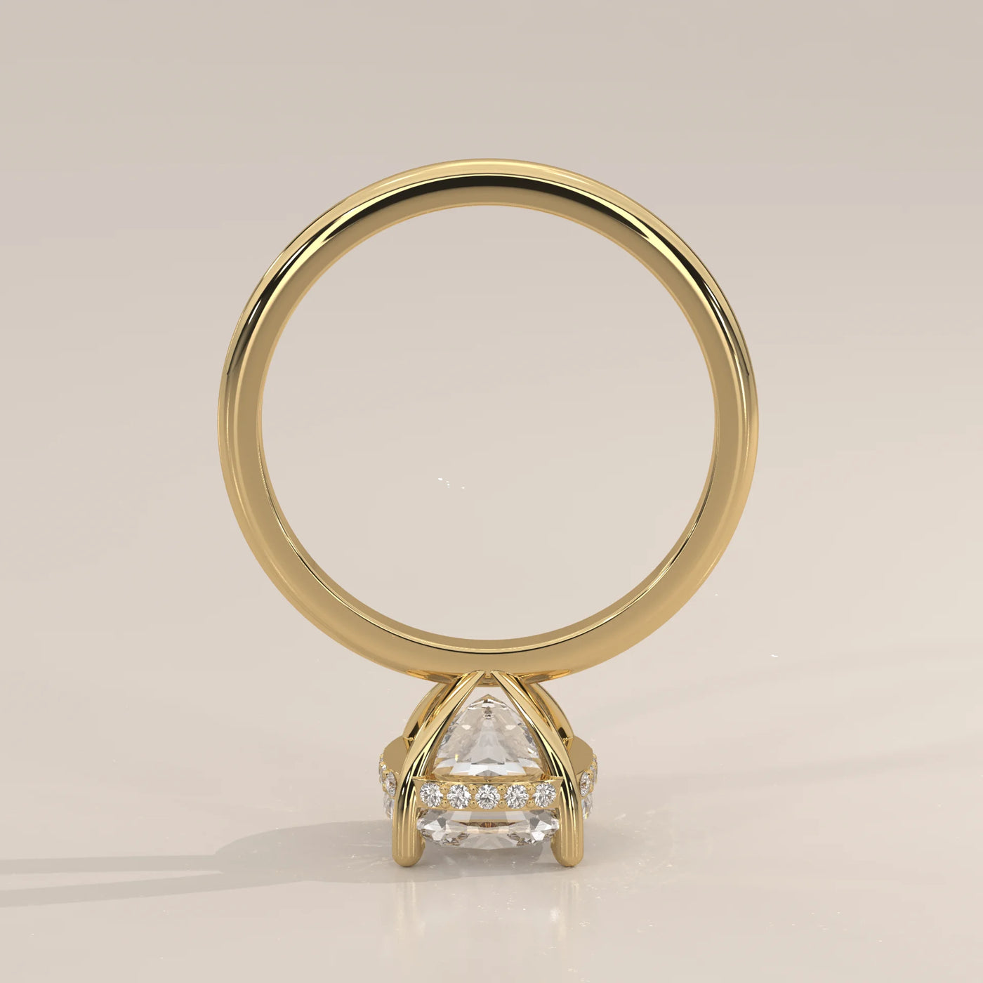 A yellow gold engagement ring with a large center diamond and pave band.