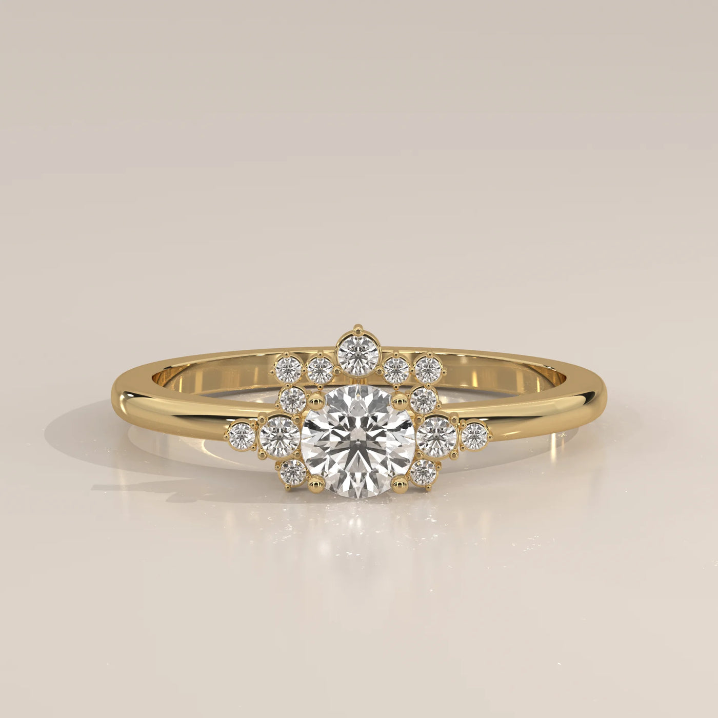 A delicate 14k yellow gold ring with a central diamond surrounded by smaller diamonds in a halo design.