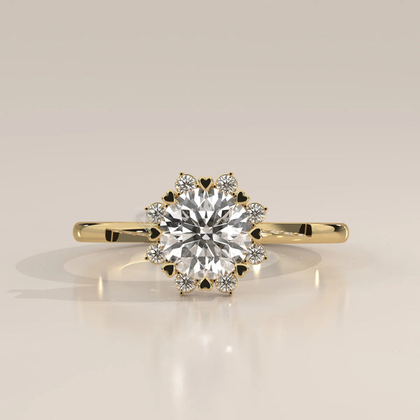 A round brilliant cut diamond engagement ring with a heart-shaped halo, set in 14k gold.