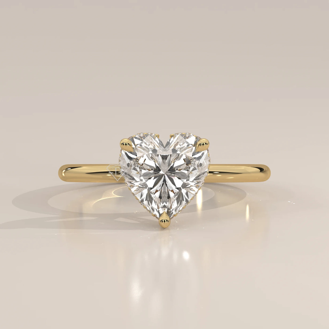 A yellow gold ring with a heart-shaped diamond in a bezel setting.