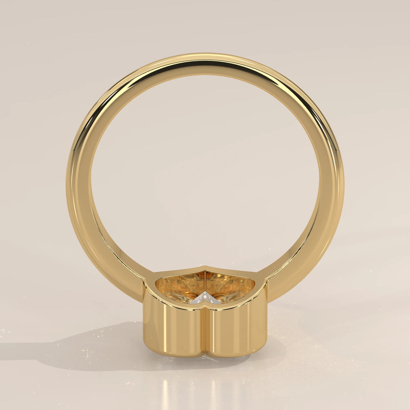 A yellow gold ring with a heart-shaped diamond and pave band.