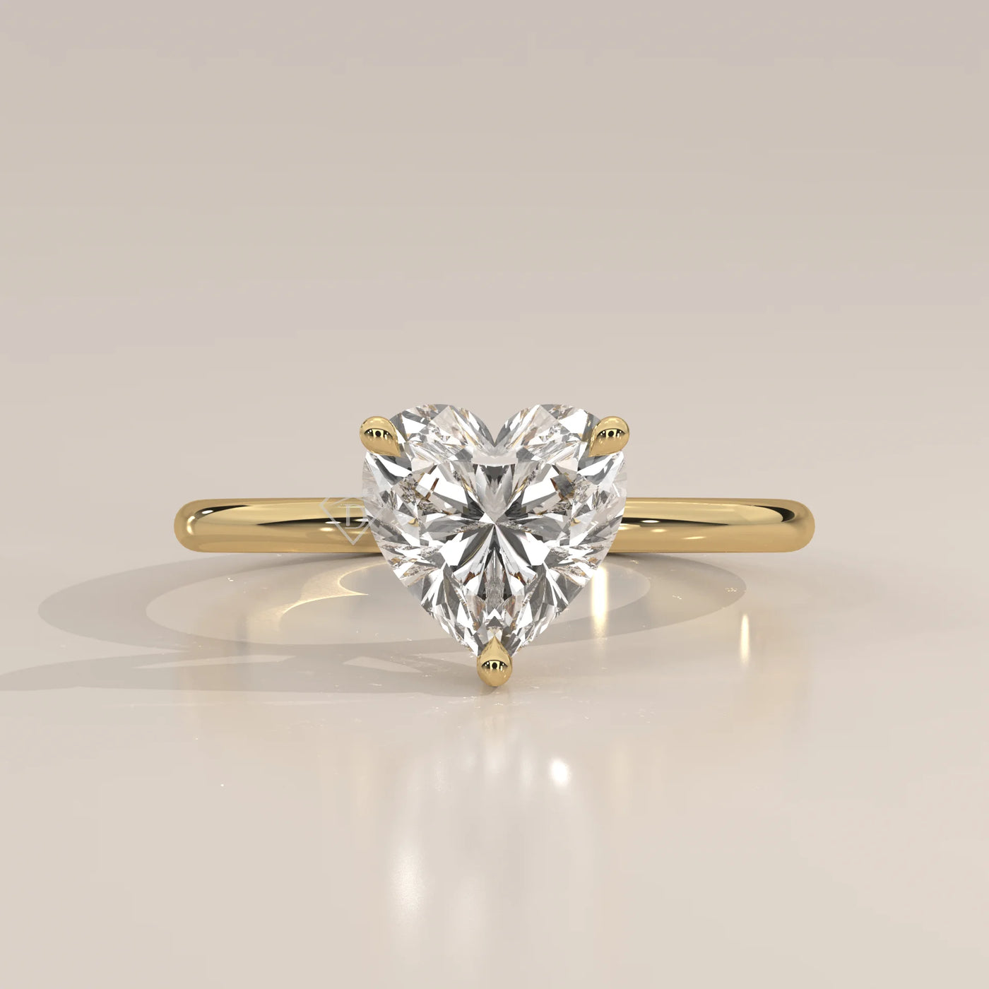 Heart shaped diamond solitaire ring in yellow gold.