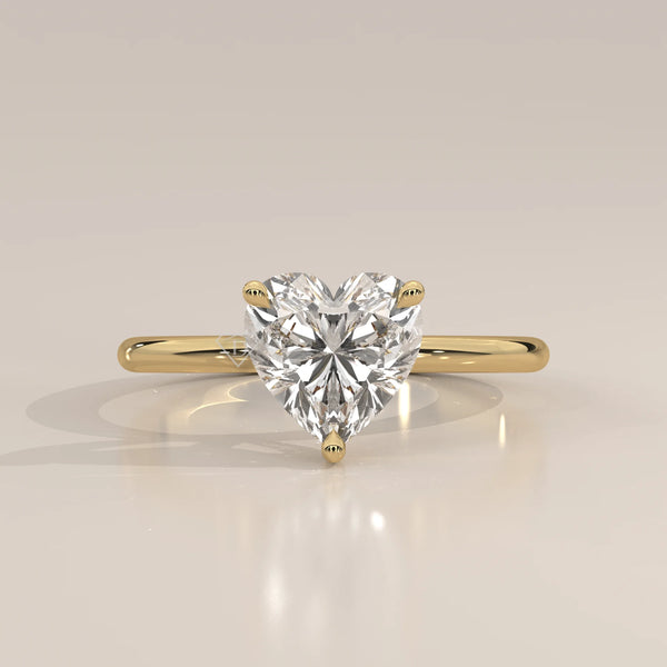Heart shaped diamond solitaire ring in yellow gold.