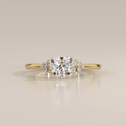 Gold ring with a heart-shaped diamond and smaller stones.
