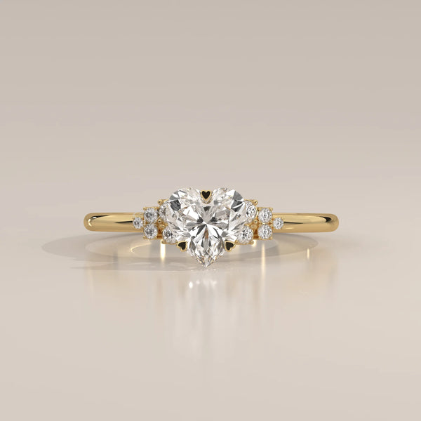 Gold ring with a heart-shaped diamond and smaller stones.