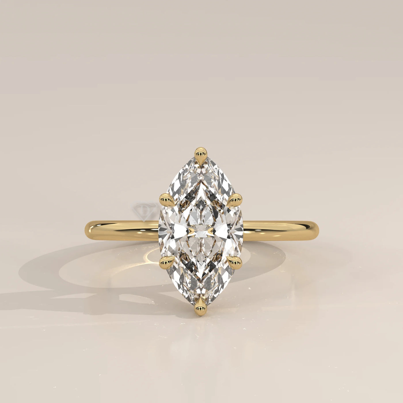 A yellow gold ring with a bezel-set marquise diamond.
