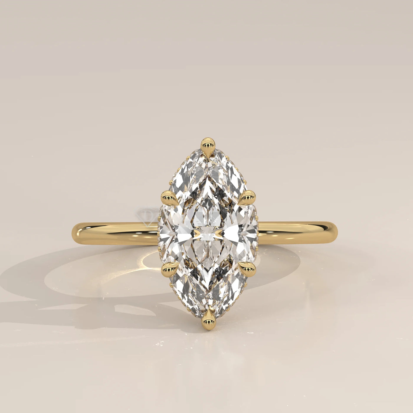 A yellow gold ring with a bezel-set marquise diamond.