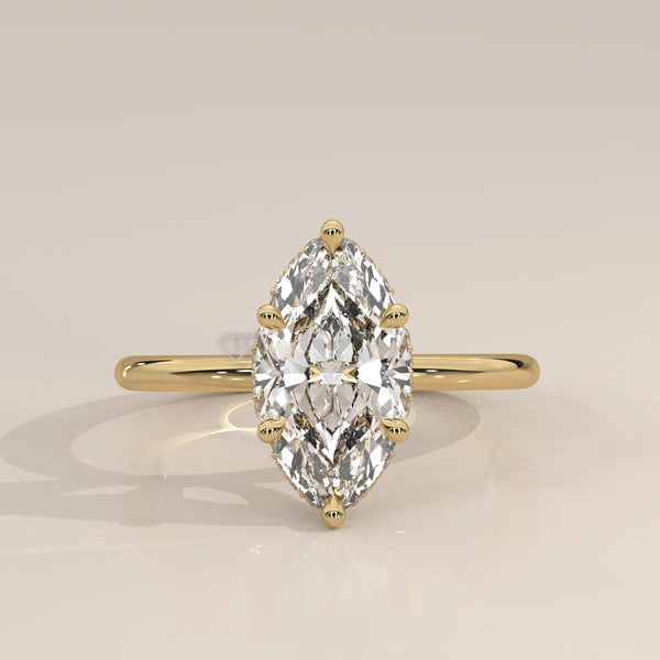 A yellow gold ring with a bezel-set marquise diamond.