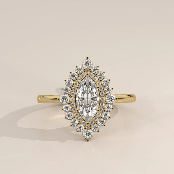 Yellow gold marquise diamond engagement ring with a halo of small diamonds.