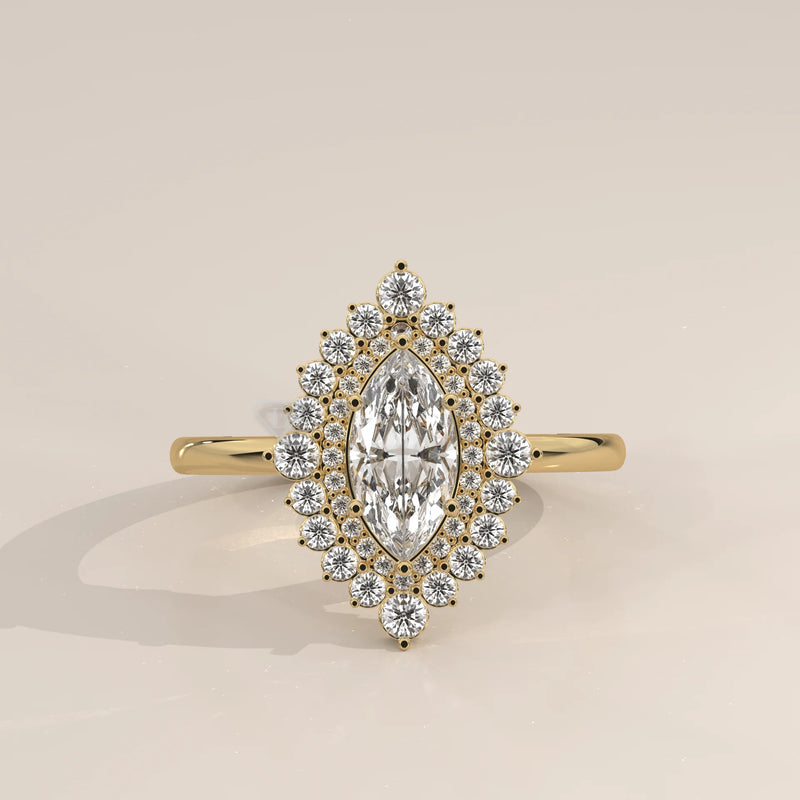 Yellow gold marquise diamond engagement ring with a halo of small diamonds.