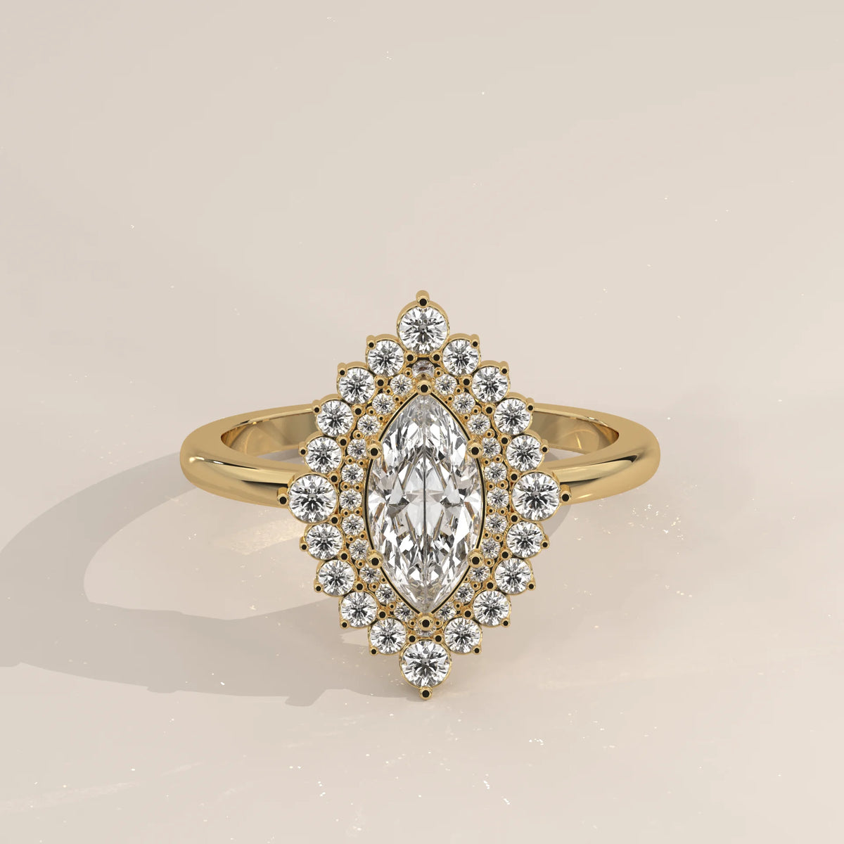 A yellow gold ring with a marquise cut diamond surrounded by a halo of small diamonds.