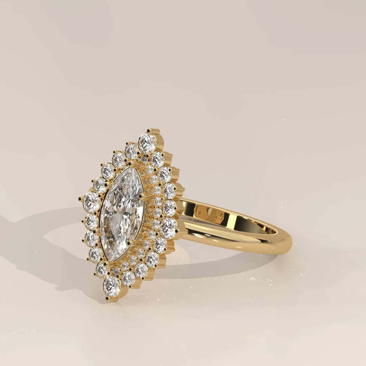 A yellow gold ring featuring a marquise-cut diamond surrounded by a halo of smaller diamonds.
