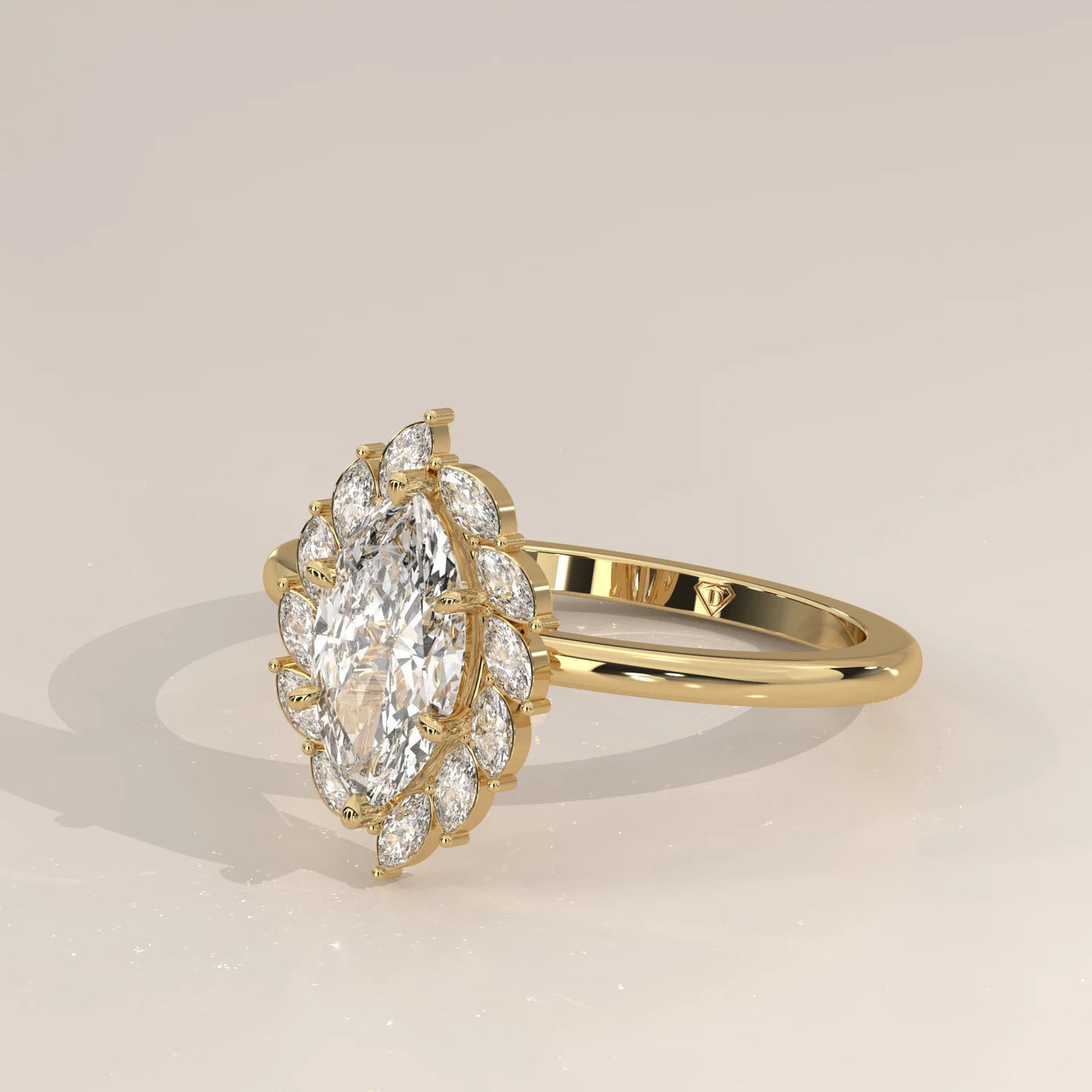 Yellow gold ring with a marquise-cut diamond surrounded by a halo of smaller diamonds.