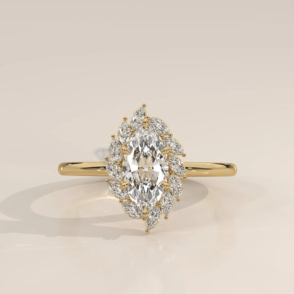 Yellow gold engagement ring with a central marquise diamond surrounded by smaller diamonds.
