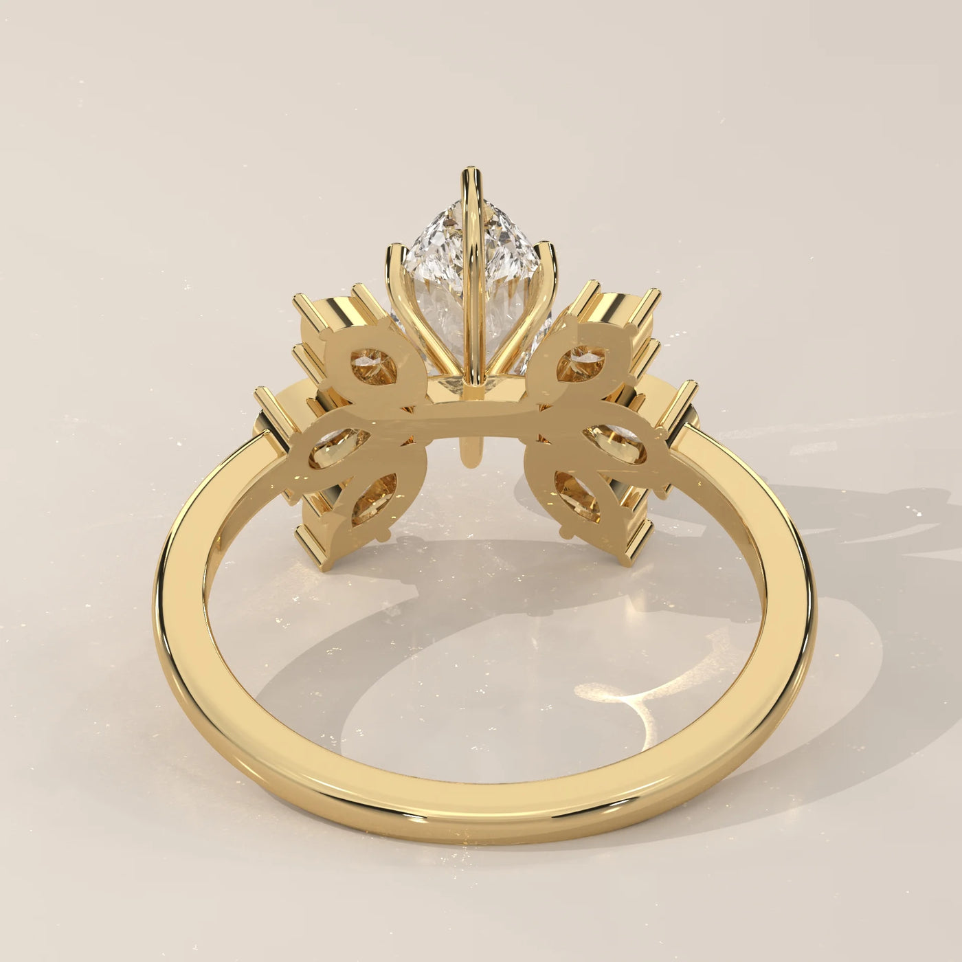 Yellow gold ring with a marquise diamond and intricate detailing.