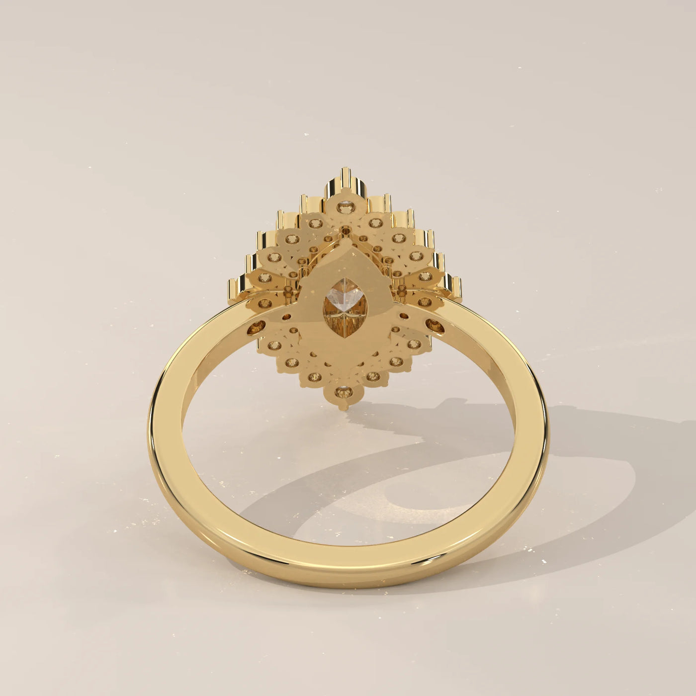 A yellow gold ring with a marquise diamond and surrounding stones, viewed from the back.