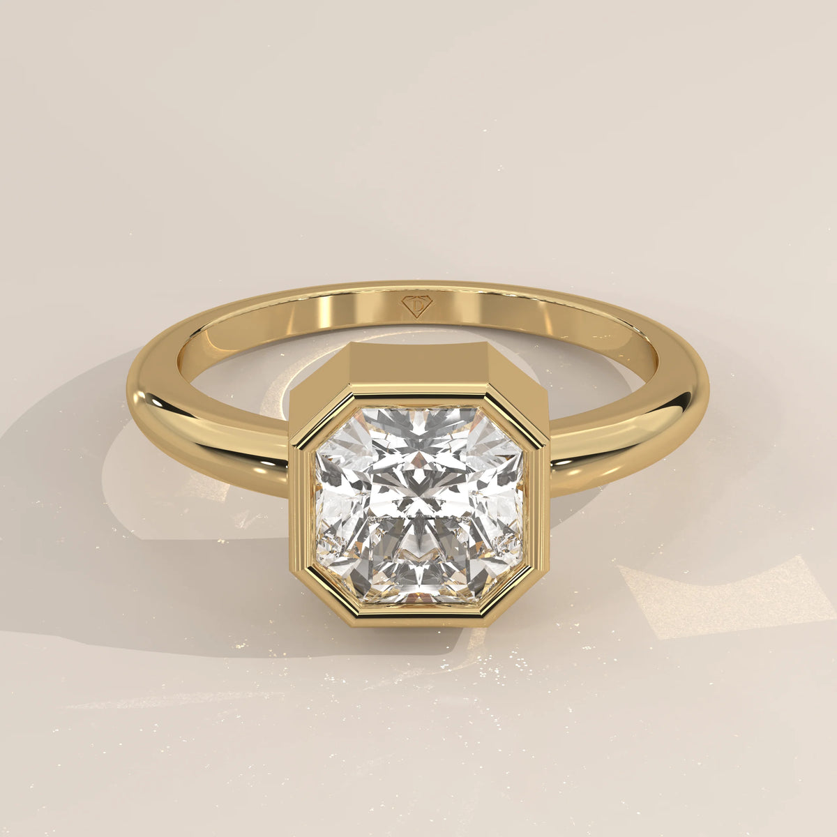 A solitaire engagement ring with an octagon-cut diamond in yellow gold.
