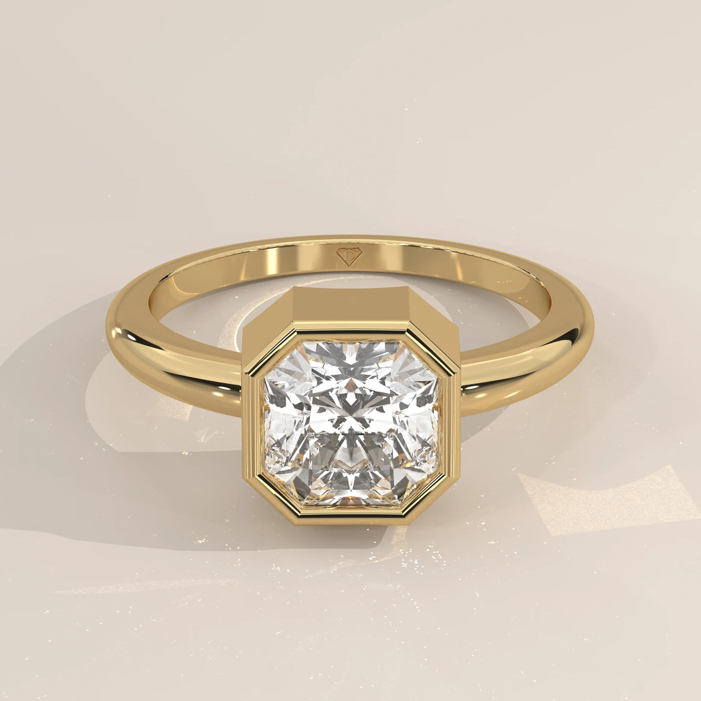 A solitaire engagement ring with an octagon-cut diamond in yellow gold.