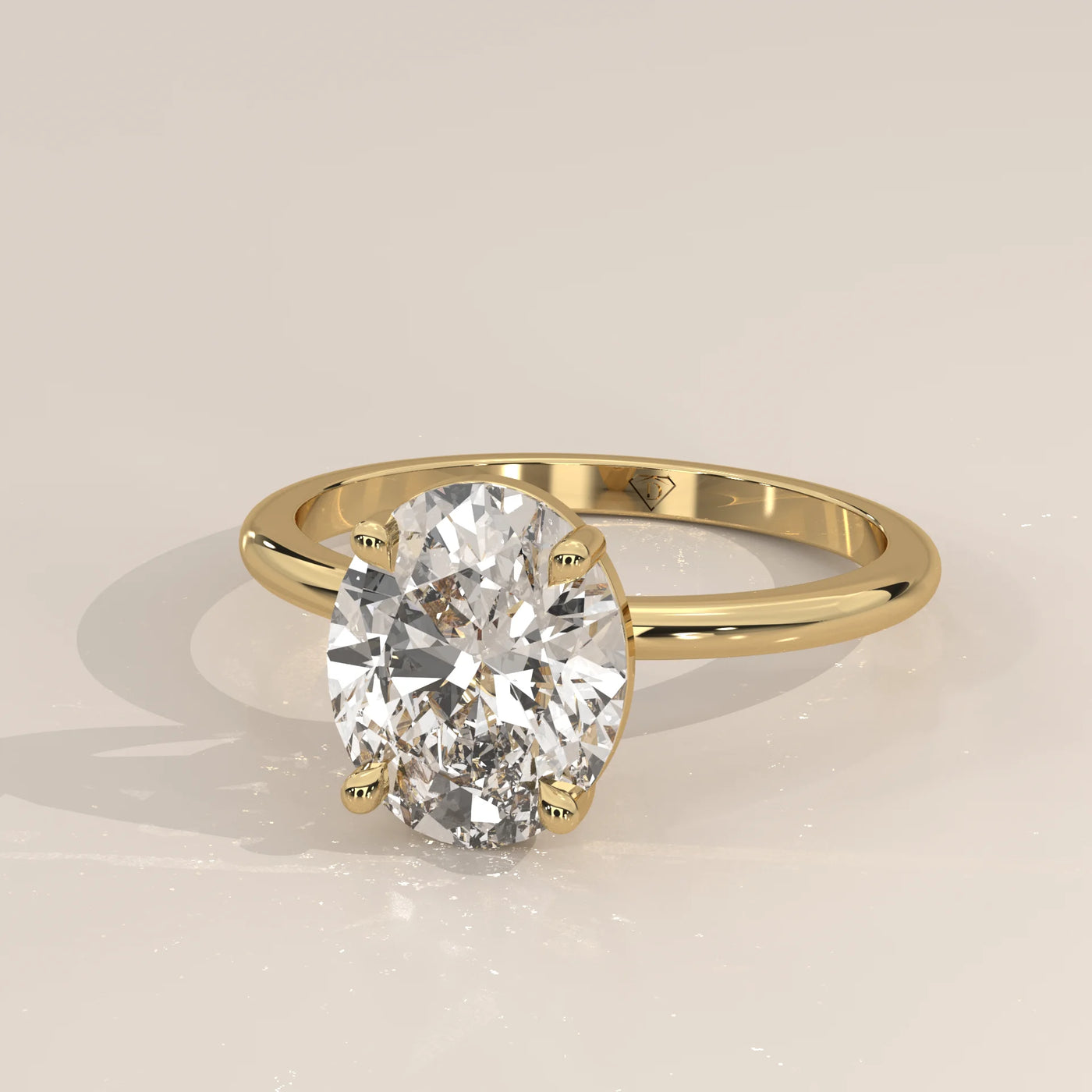 Oval diamond solitaire ring in yellow gold with a simple band.