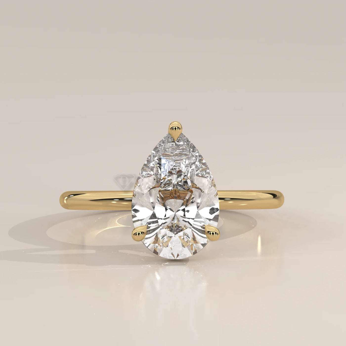 A classic yellow gold ring with a large pear-cut diamond.