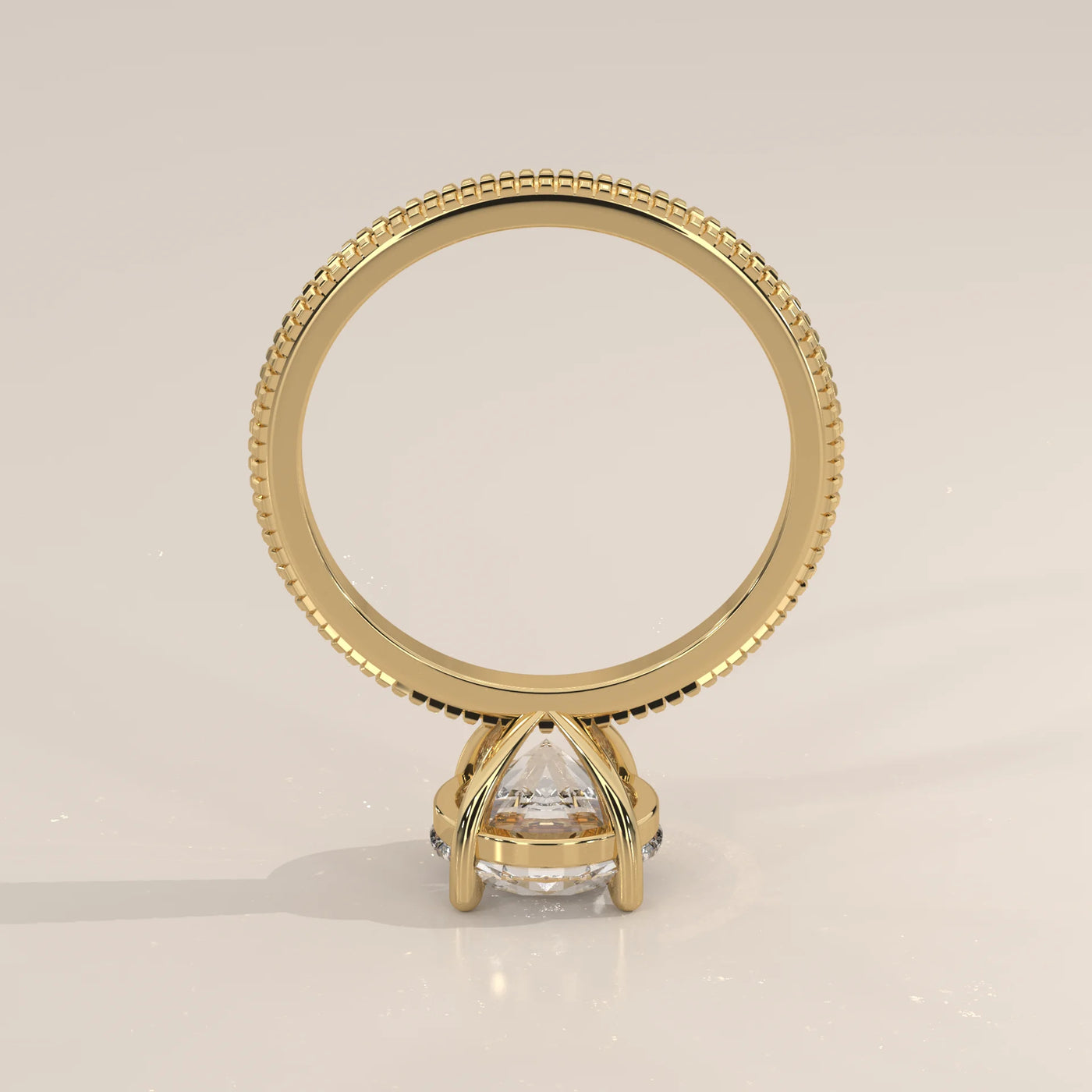 A 14k yellow gold ring with a pear-cut diamond.