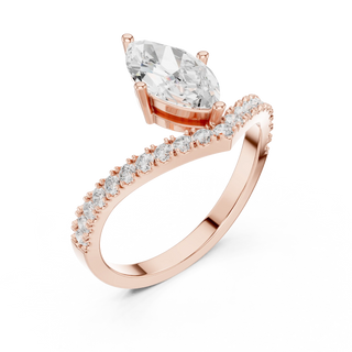 Angled view of a beautiful ring: Pear Diamond Ring with Bypass Pave and Prong Setting in 14k Rose Gold – Lab Grown – Driona Jewels
