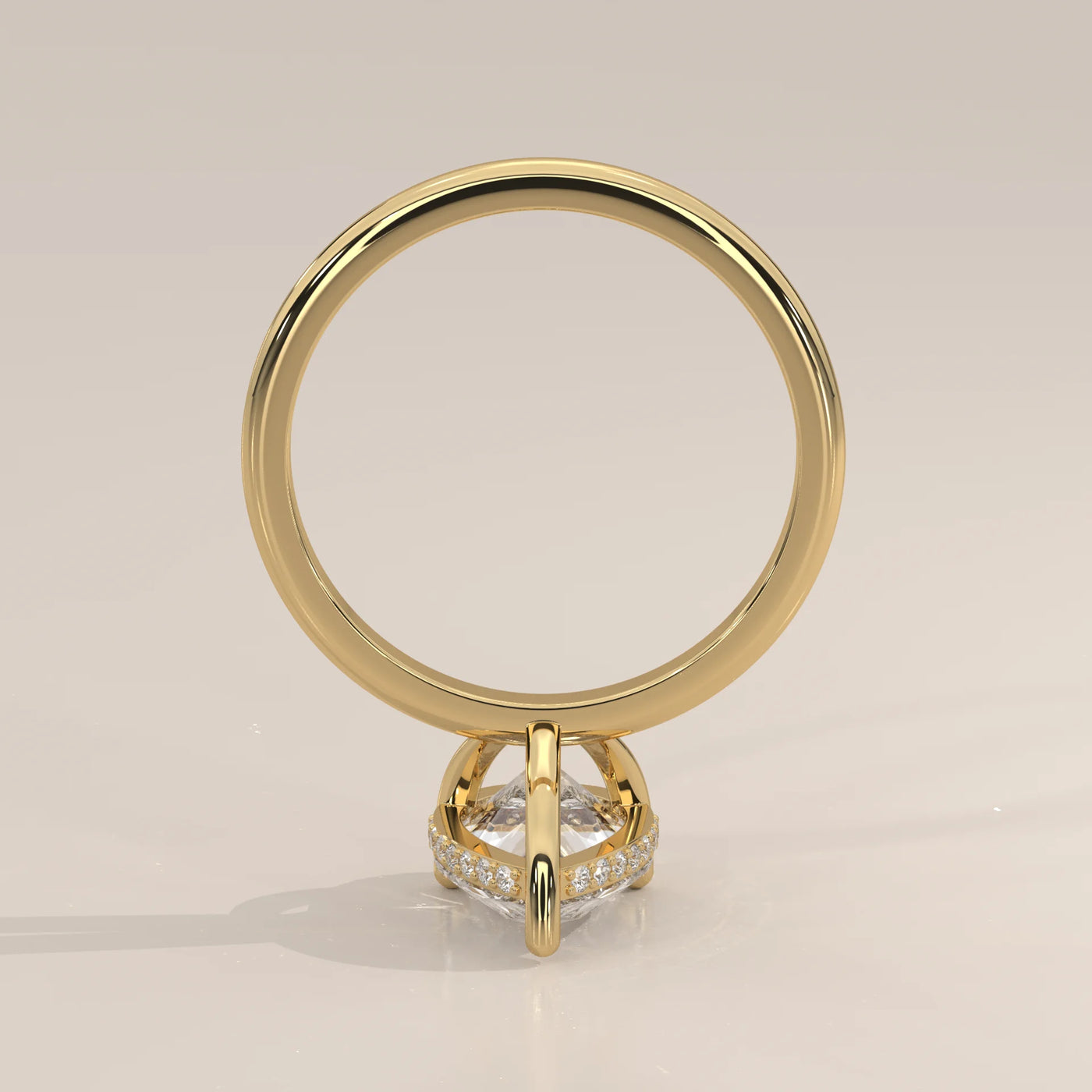 A 14k gold ring with a pear-shaped diamond and pave band.