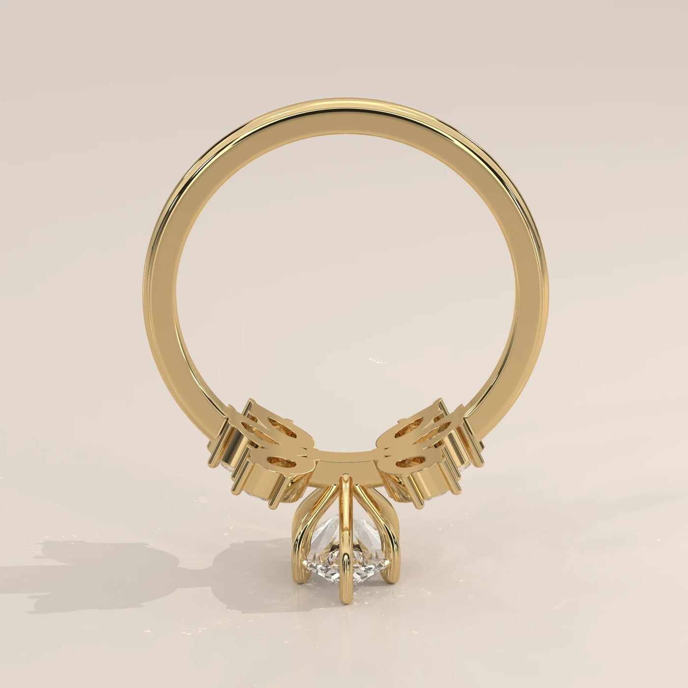A 14k gold ring with a pear-cut diamond and intricate detailing.