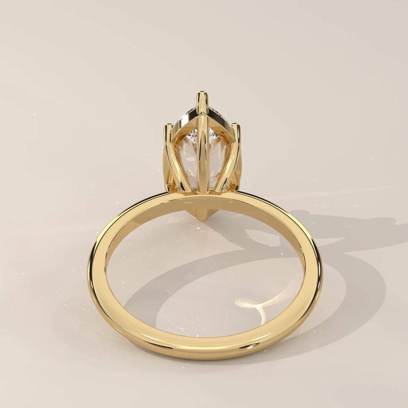 A classic 14k yellow gold ring with a pear-cut diamond and pave accents.