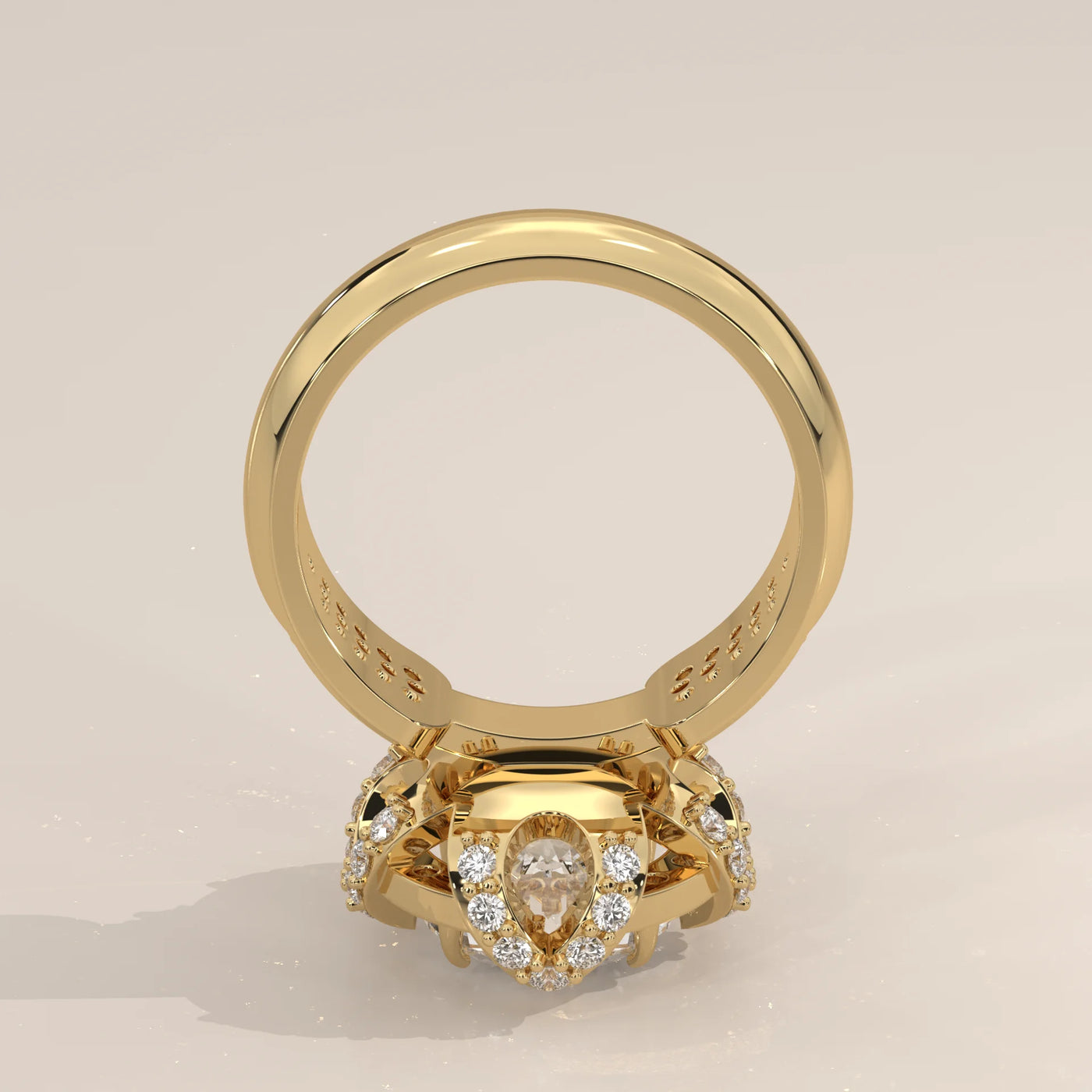 Yellow gold ring with a pear-shaped diamond and smaller accent diamonds.
