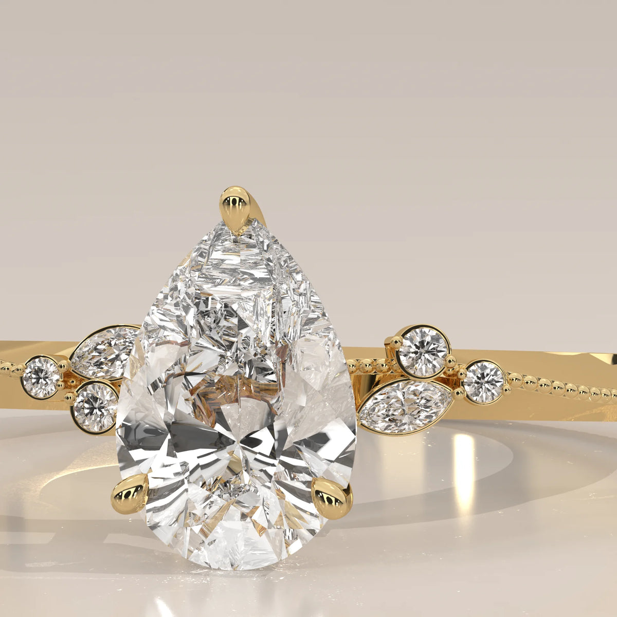 A delicate gold ring featuring a prominent pear-shaped diamond surrounded by smaller accent stones.