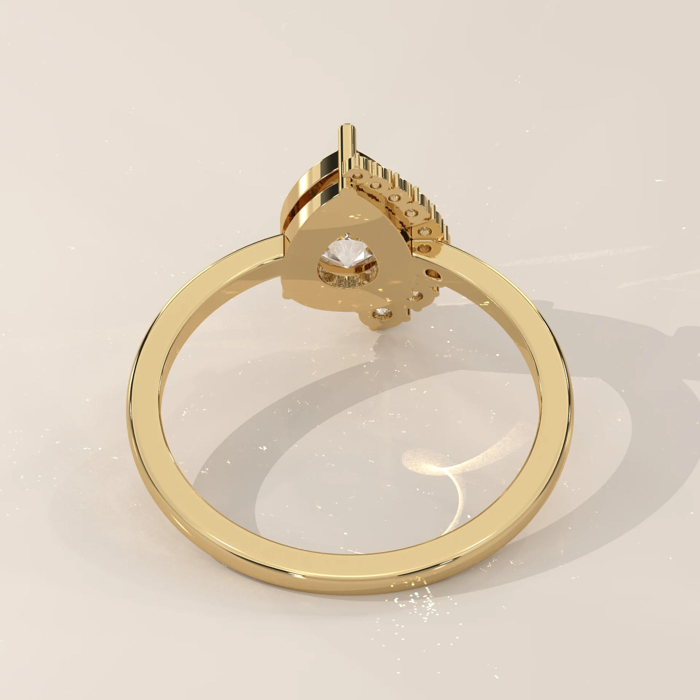 Gold ring with a pear-shaped diamond and small accent stones.