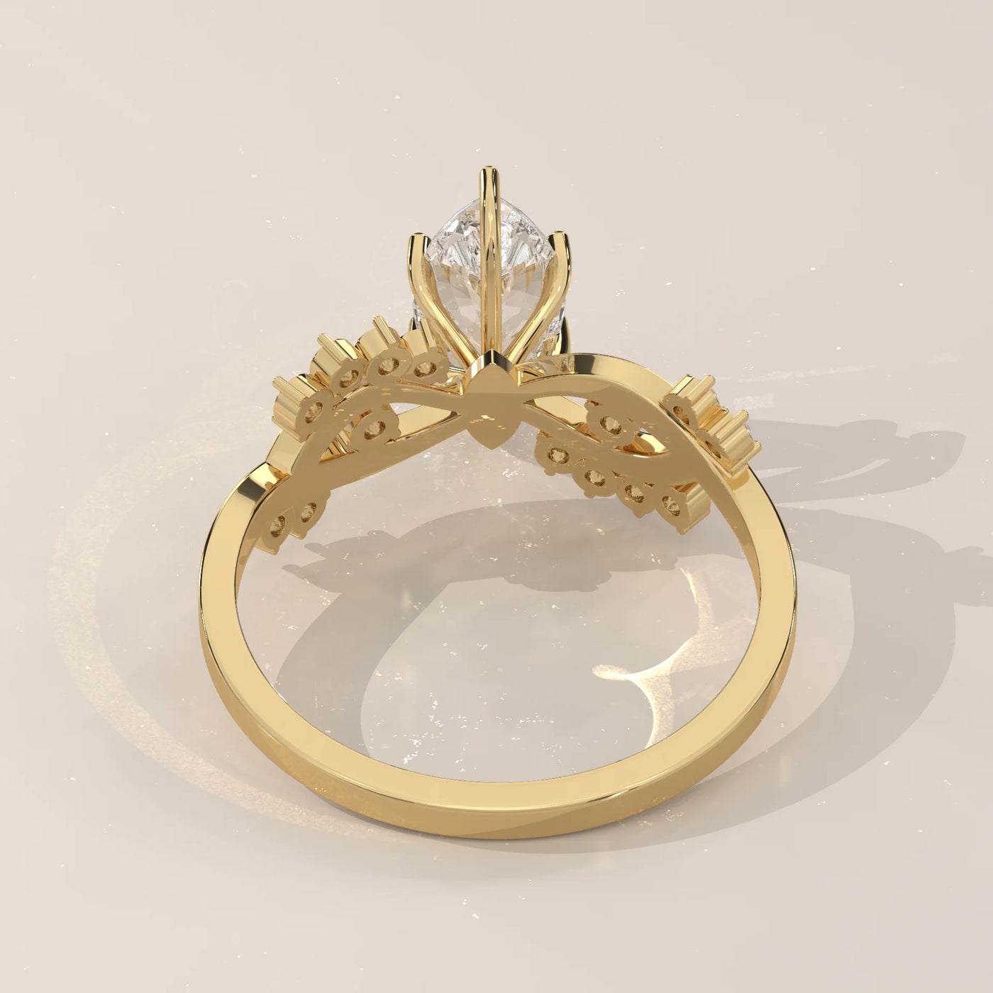 A yellow gold ring with a pear-shaped diamond and smaller stones.