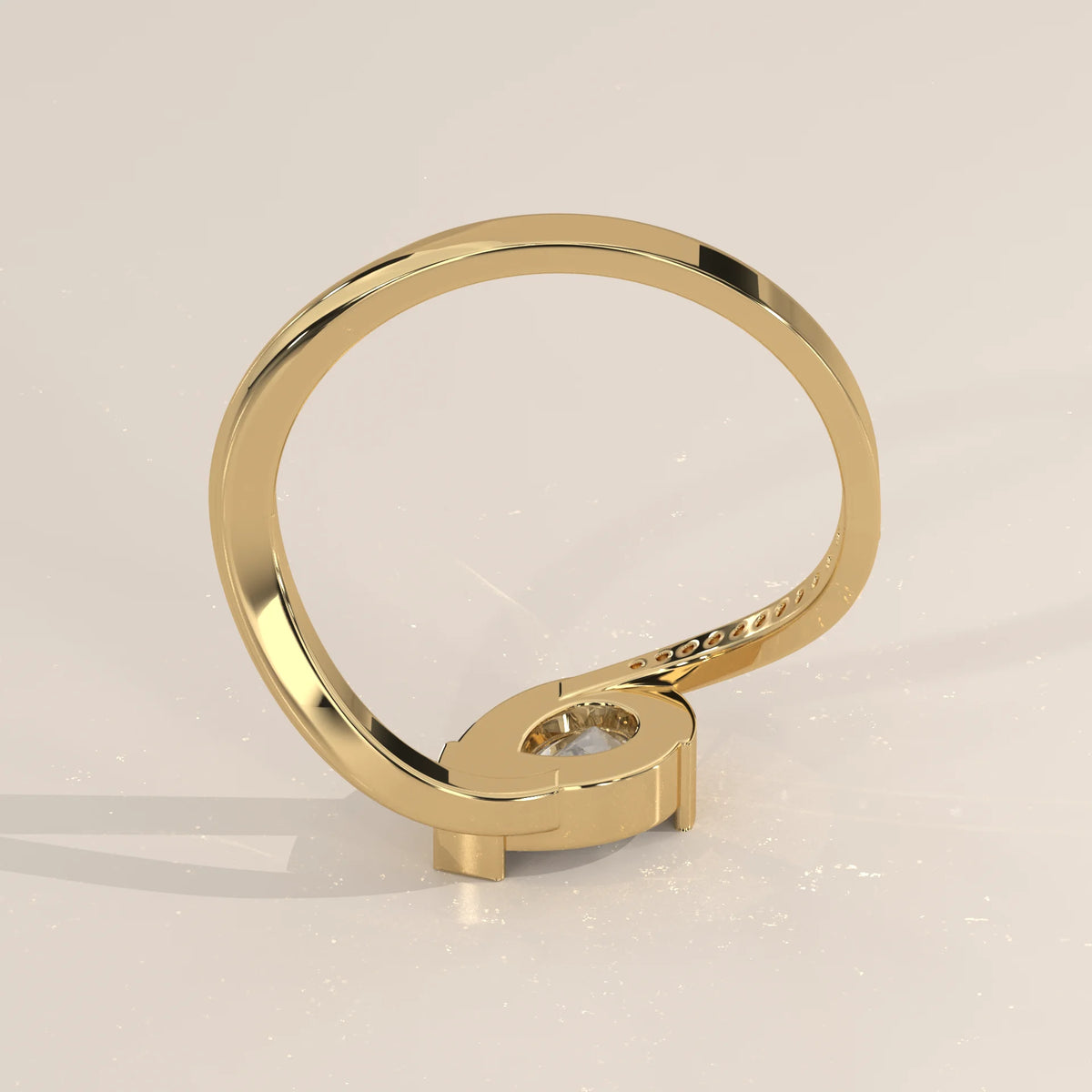 Pear Lab Grown Diamond Bypass Ring with Half Bezel and Pave Shoulder in yellow gold, photographed from the side.