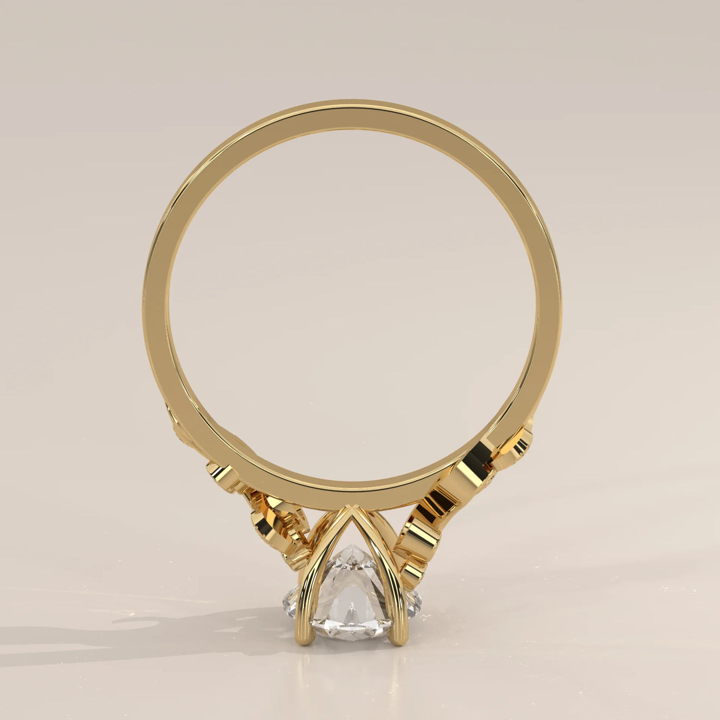 Gold engagement ring with a pear-shaped diamond and intricate band details.