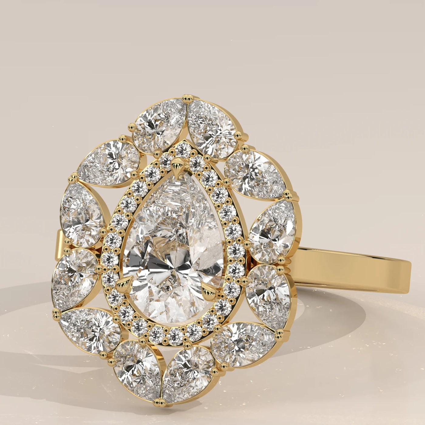 A vintage-inspired 14k gold ring with a large pear-shaped diamond and surrounding smaller diamonds.