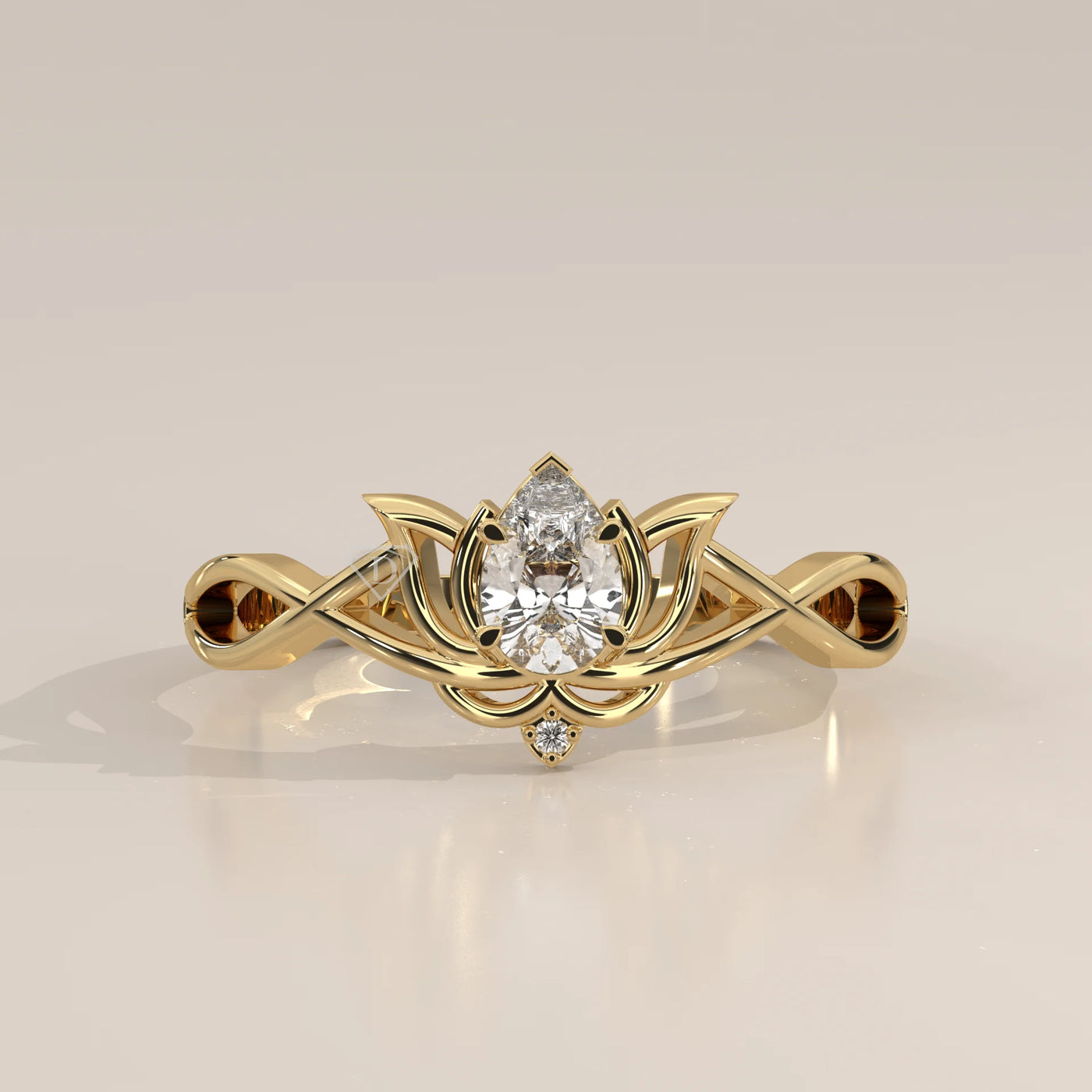 A yellow gold ring with a pear-shaped diamond center stone in a lotus design.