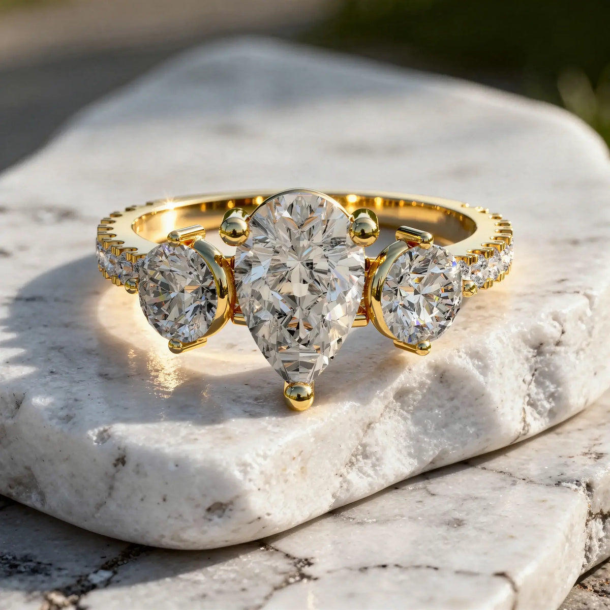 Close-up: Pear Cut Diamond Ring with Three Stone Setting in 14k Yellow Gold - Lab Grown - Driona Jewels