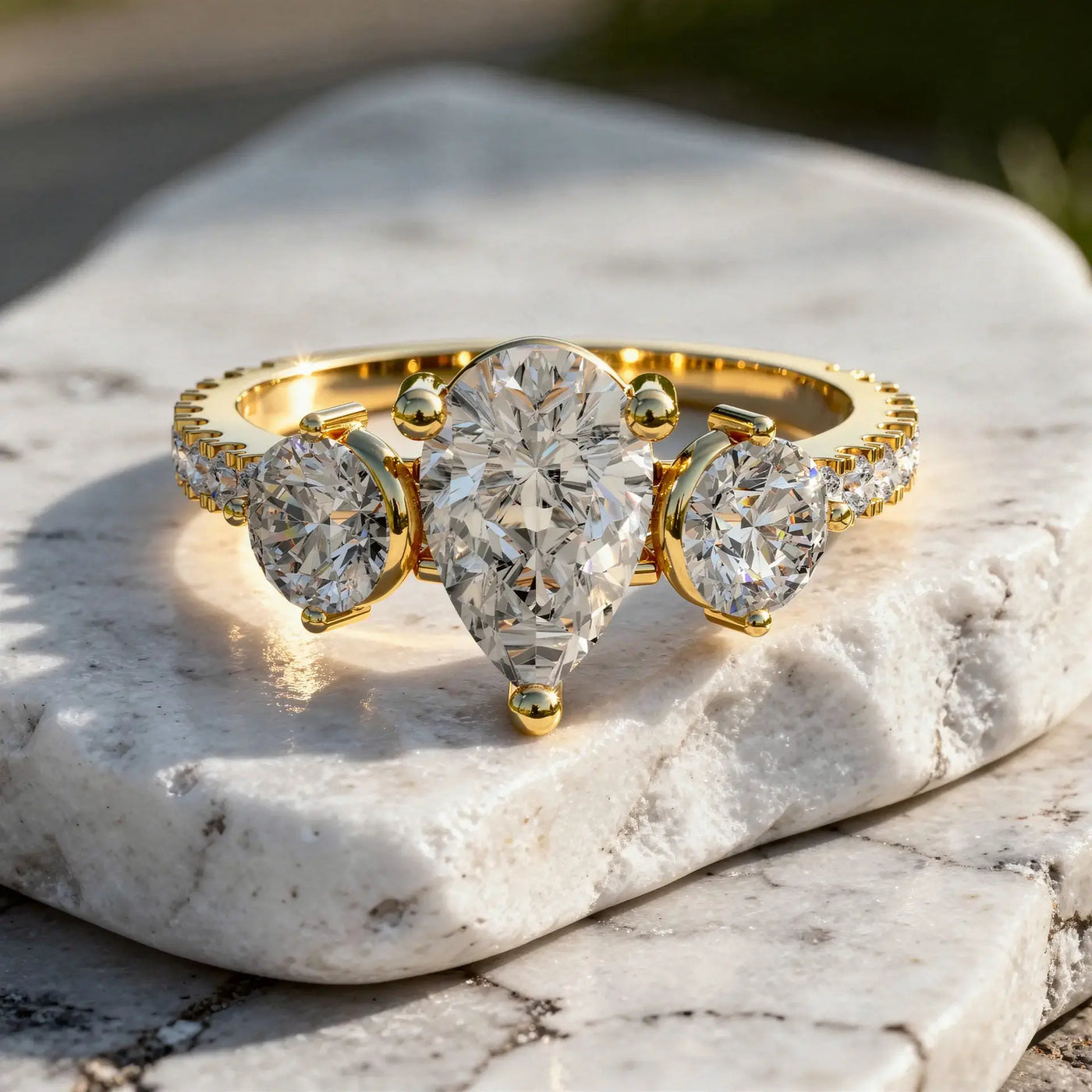 Close-up: Pear Cut Diamond Ring with Three Stone Setting in 14k Yellow Gold - Lab Grown - Driona Jewels